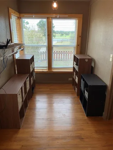 a hallway with wooden floor and furniture