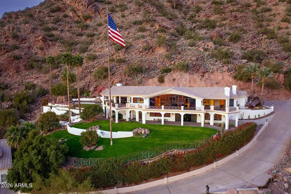a aerial view of a house with a big yard and potted plants