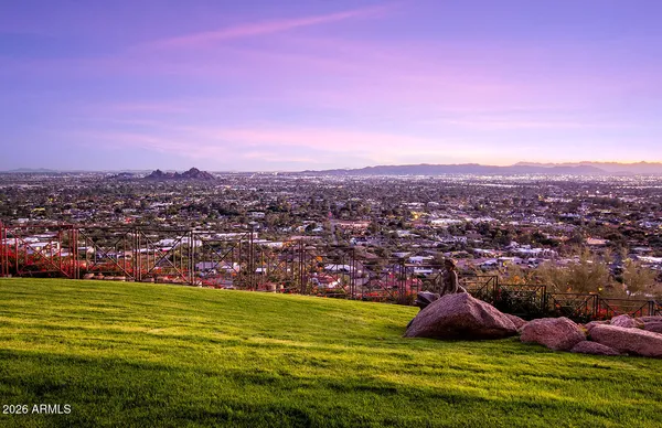 a view of a park with swings and a fire pit