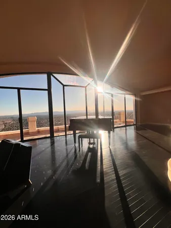 a living room with furniture a lamp wooden floor and a large window