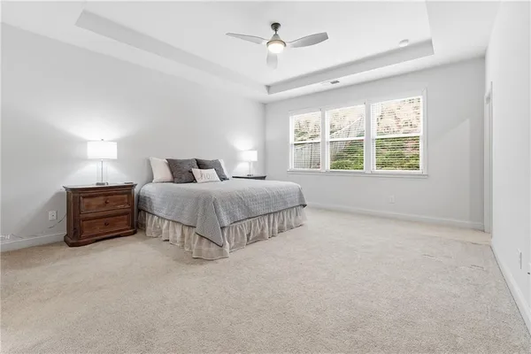 a bedroom with a large bed and a chandelier
