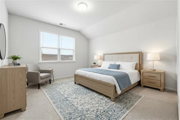 a bedroom with a bed and a couch