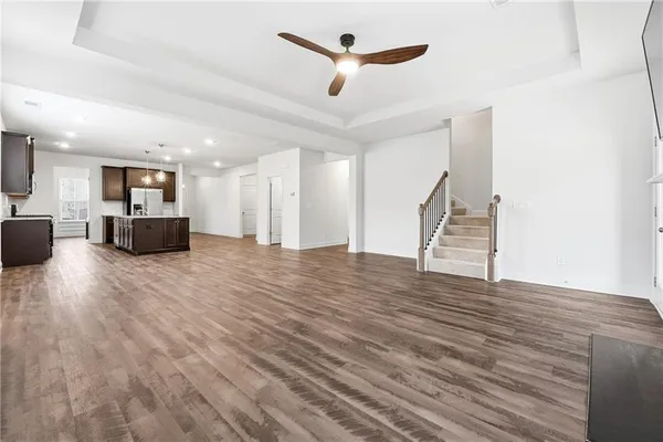 a kitchen with stainless steel appliances kitchen island granite countertop a stove and a refrigerator