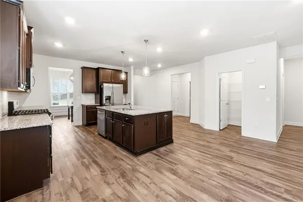 a kitchen with stainless steel appliances granite countertop counter space a sink stove and cabinets