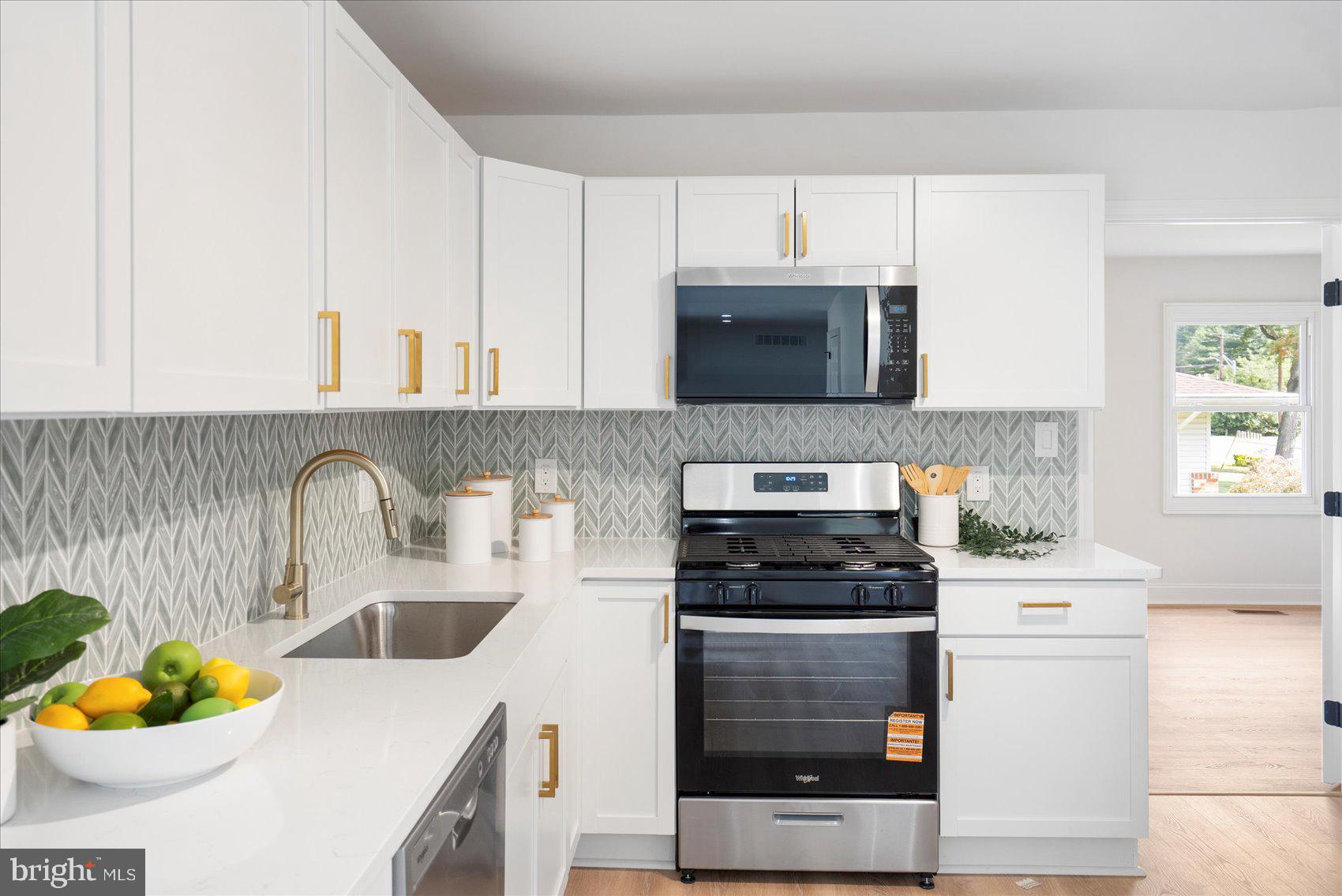 226 Mt Royal Avenue Aberdeen, MD 21001 - Photo 19 of 48 a kitchen with a stove a sink and a microwave