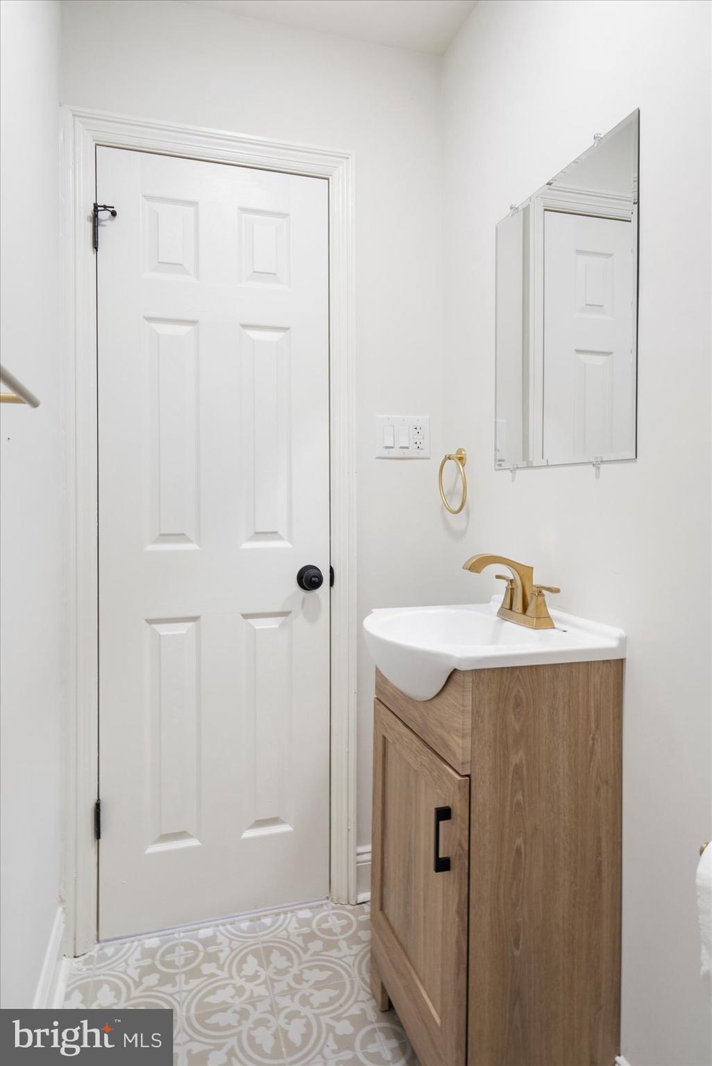 226 Mt Royal Avenue Aberdeen, MD 21001 - Photo 42 of 48 a bathroom with a sink and a mirror