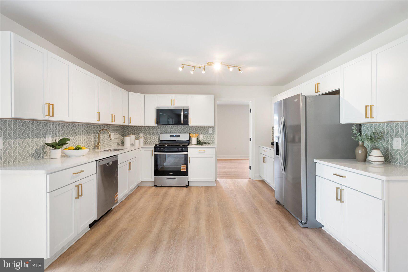 226 Mt Royal Avenue Aberdeen, MD 21001 - Photo 8 of 48 a kitchen with white cabinets and stainless steel appliances