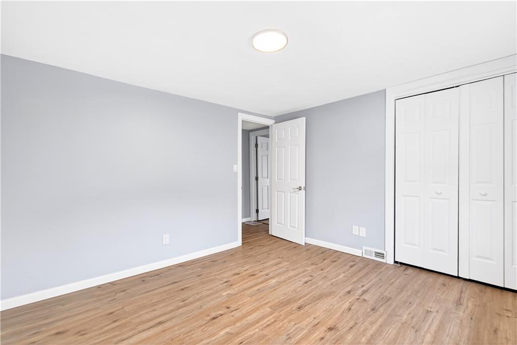 93 Old 51 Road Perryopolis, PA 15473 - Photo 26 of 44 a view of an empty room with wooden floor