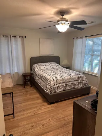 a bedroom with a bed and a chandelier