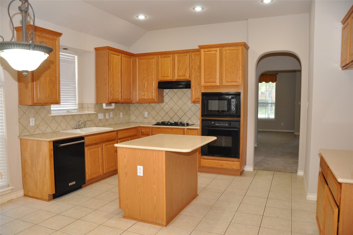 16616 Dalmahoy Drive Austin, TX 78717 - Photo 4 of 31 a kitchen with stainless steel appliances granite countertop a stove and a refrigerator
