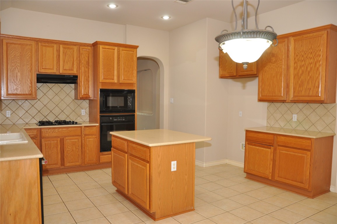 16616 Dalmahoy Drive Austin, TX 78717 - Photo 5 of 31 a kitchen with stainless steel appliances granite countertop a sink counter space cabinets and a stove