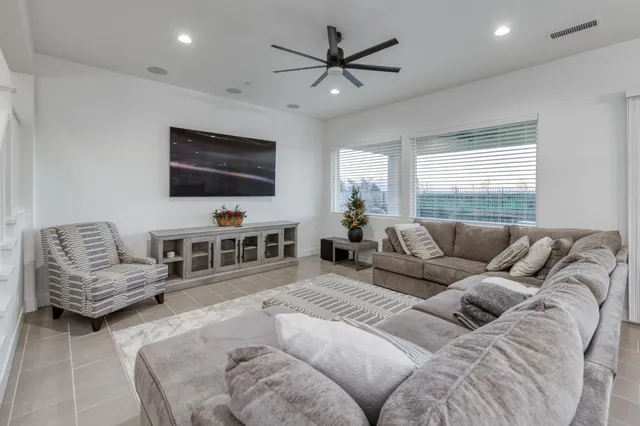 a kitchen with a dining table chairs and refrigerator