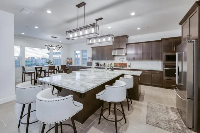 a kitchen with cabinets a counter and chairs