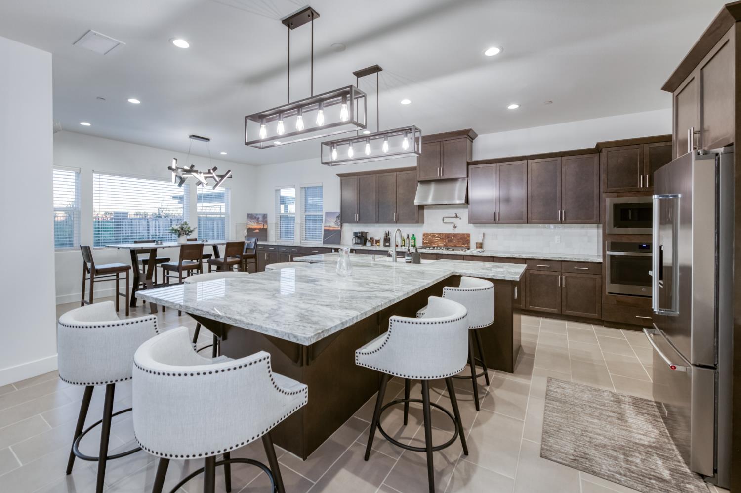 1042 Beaver Pond Loop Madera, CA 93636 - Photo 15 of 61 a kitchen with kitchen island a dining table and chairs