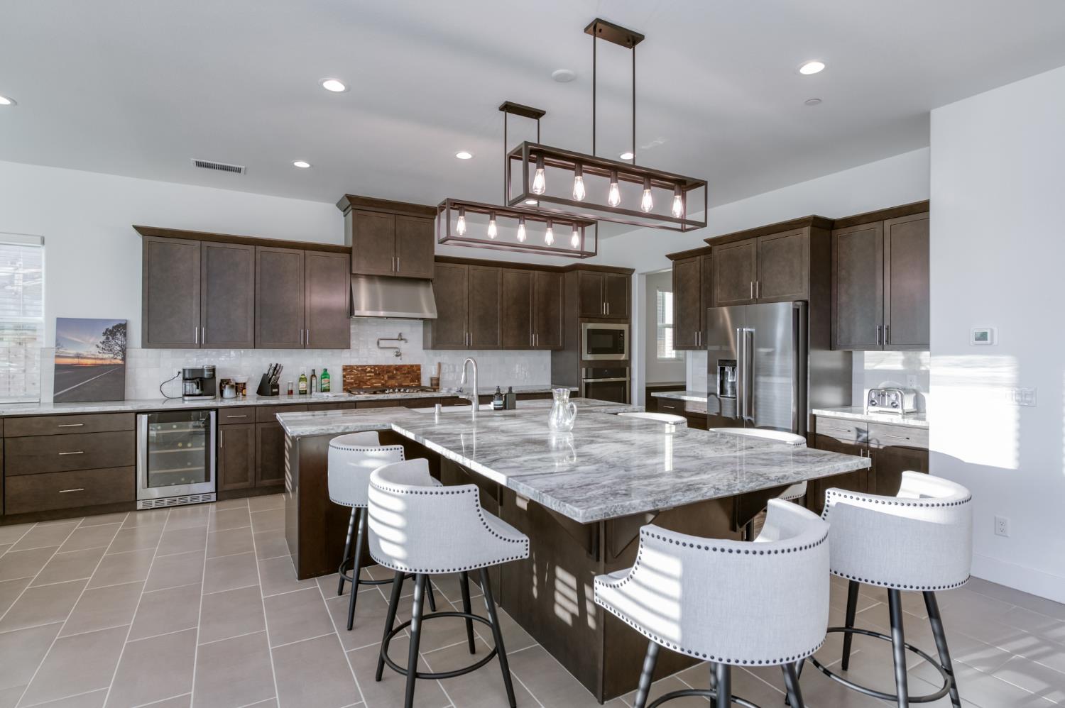 1042 Beaver Pond Loop Madera, CA 93636 - Photo 18 of 61 a kitchen with a dining table chairs and refrigerator