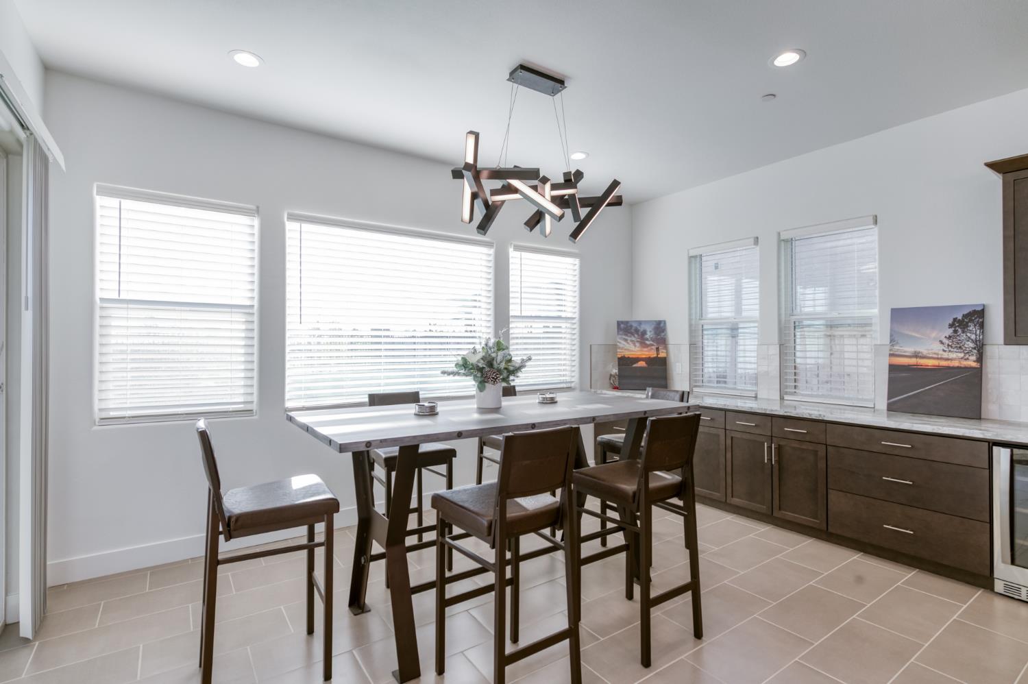 1042 Beaver Pond Loop Madera, CA 93636 - Photo 19 of 61 a kitchen with a table and chairs in it