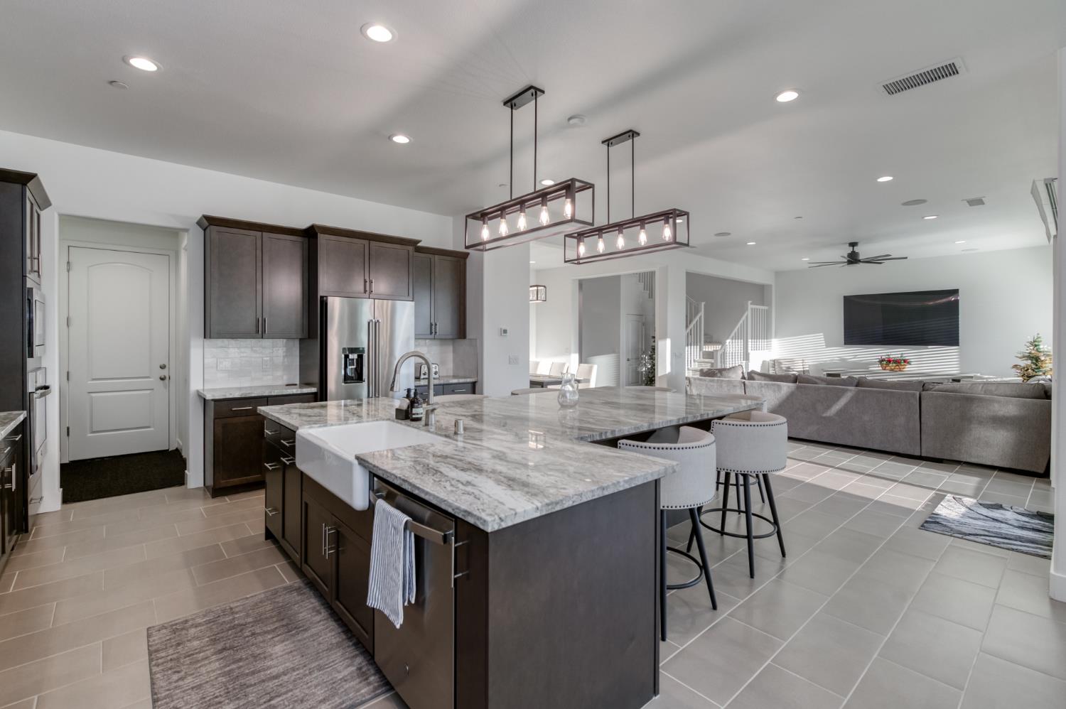 1042 Beaver Pond Loop Madera, CA 93636 - Photo 21 of 61 a kitchen with cabinets a counter and chairs