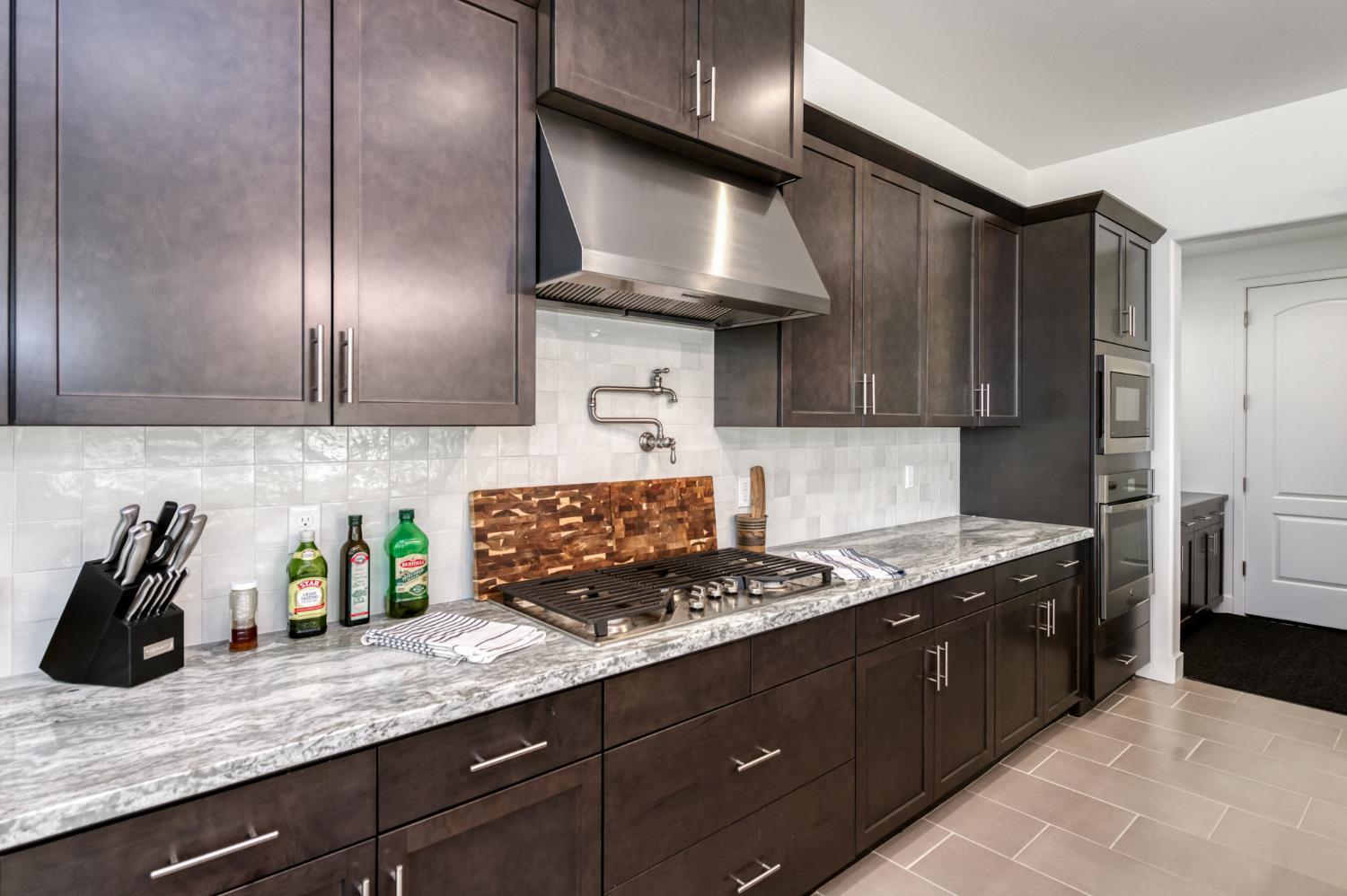 1042 Beaver Pond Loop Madera, CA 93636 - Photo 22 of 61 a kitchen with stainless steel appliances granite countertop a sink a stove and a refrigerator