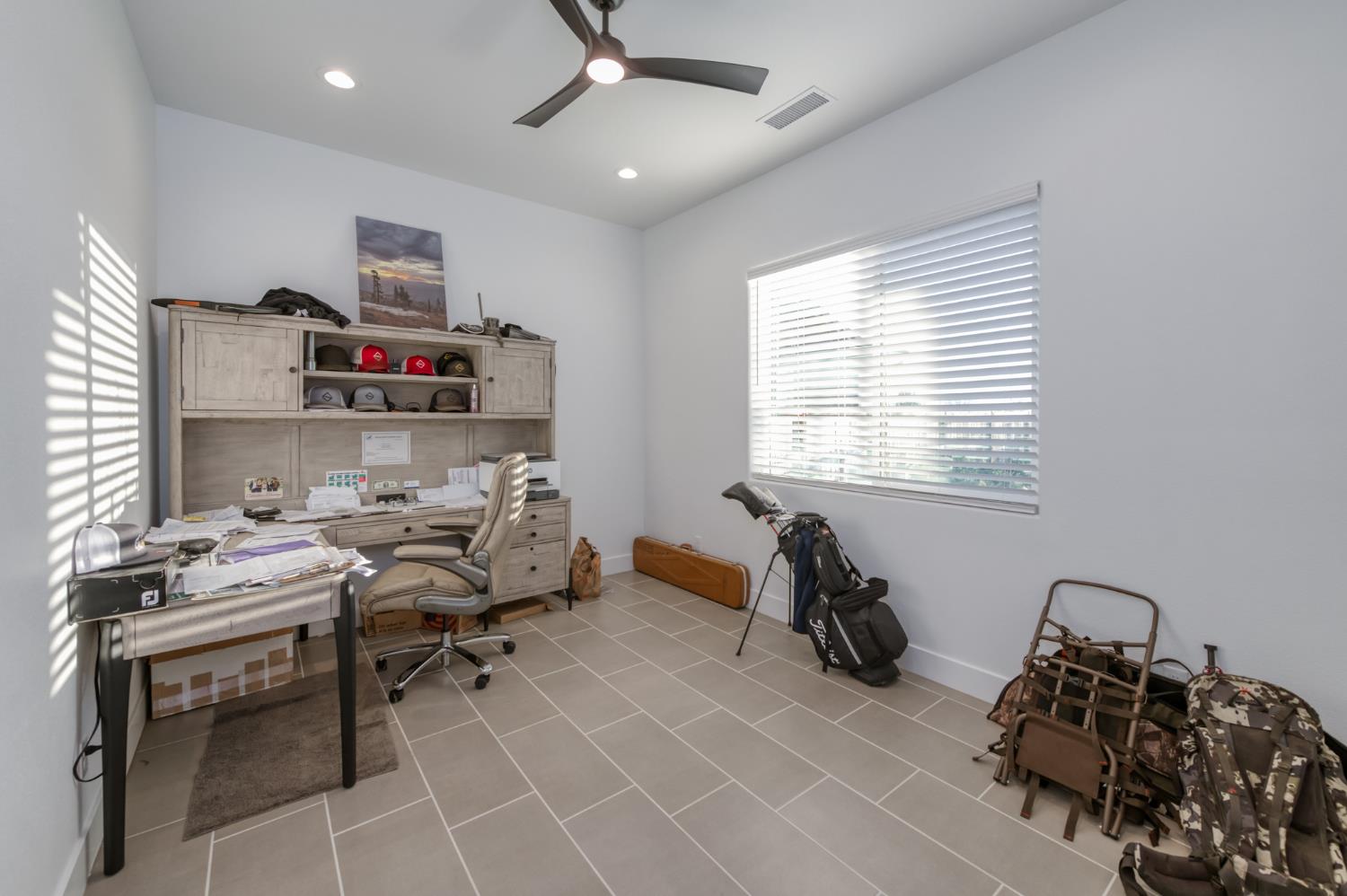1042 Beaver Pond Loop Madera, CA 93636 - Photo 29 of 61 a room with furniture a chandelier and a window