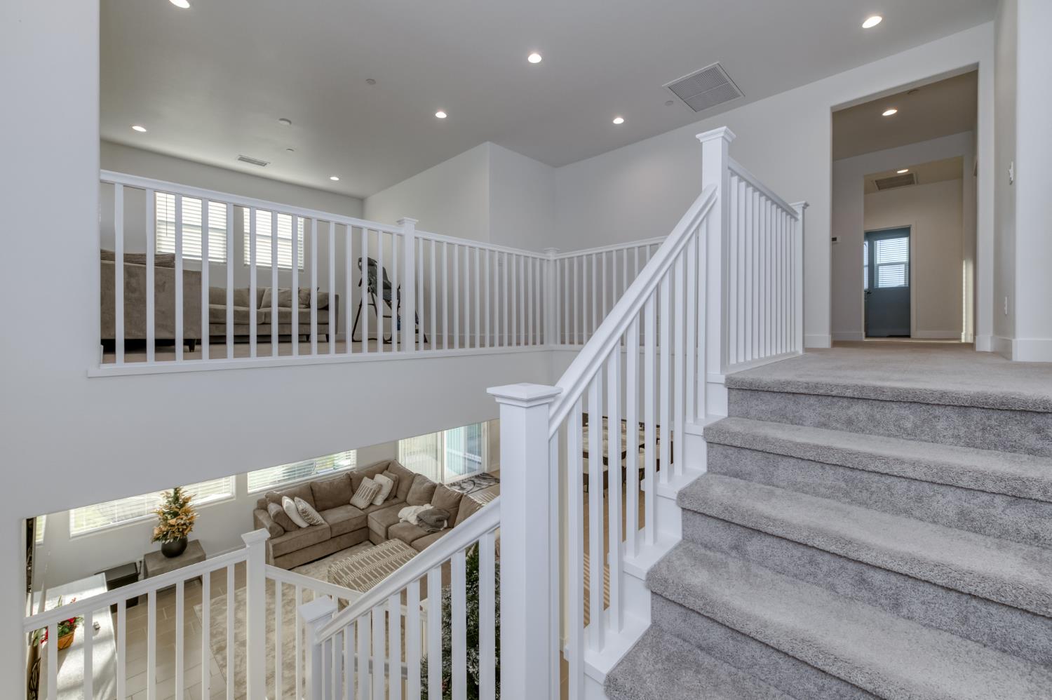 1042 Beaver Pond Loop Madera, CA 93636 - Photo 30 of 61 a view of a hallway with windows and stairs