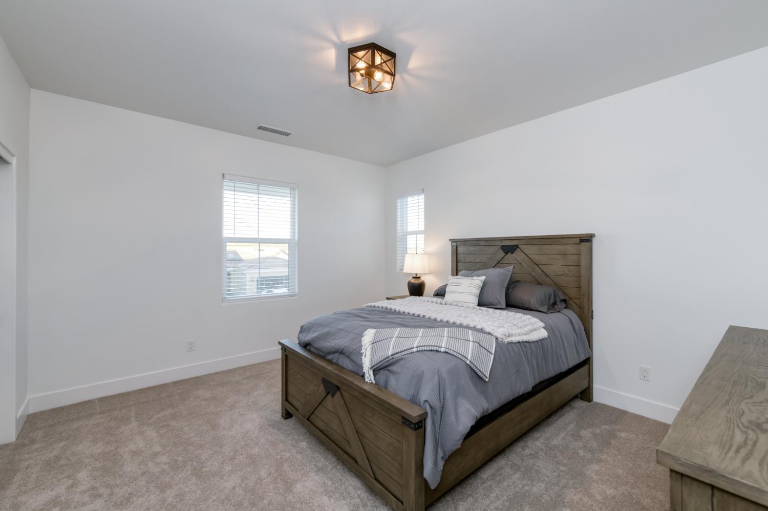 1042 Beaver Pond Loop Madera, CA 93636 - Photo 34 of 61 a bedroom with a bed and window