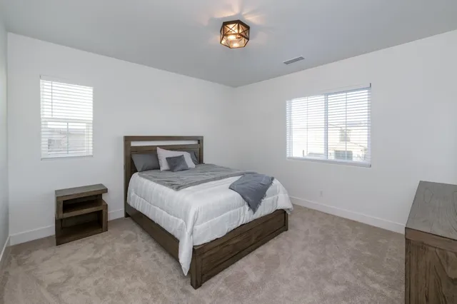 a spacious bedroom with a bed and a couch