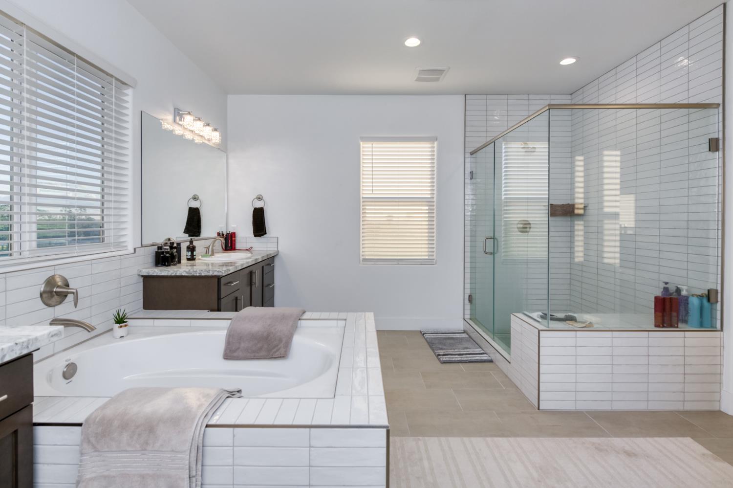 1042 Beaver Pond Loop Madera, CA 93636 - Photo 42 of 61 a bathroom with a tub sink and mirror