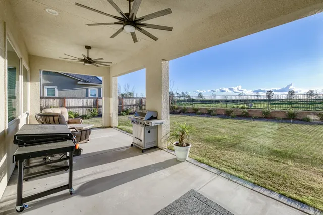 an aerial view of residential houses with outdoor space and city view