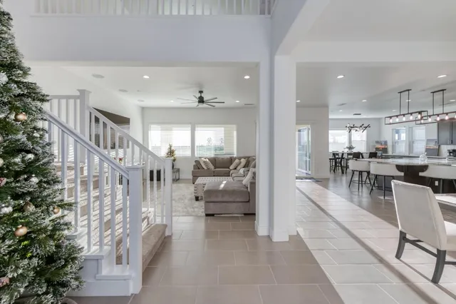 a living room with furniture and a flat screen tv with kitchen view
