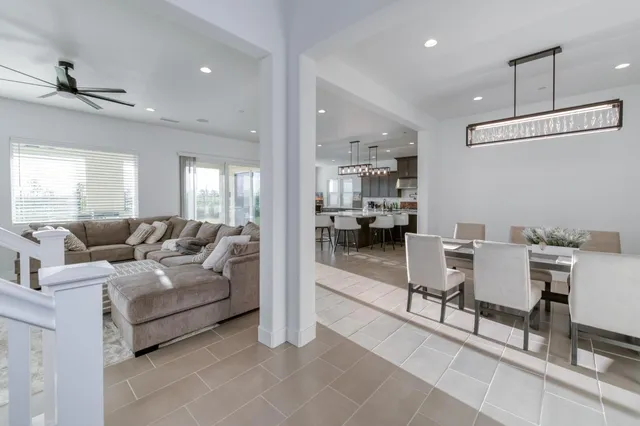 a living room with furniture and a view of kitchen