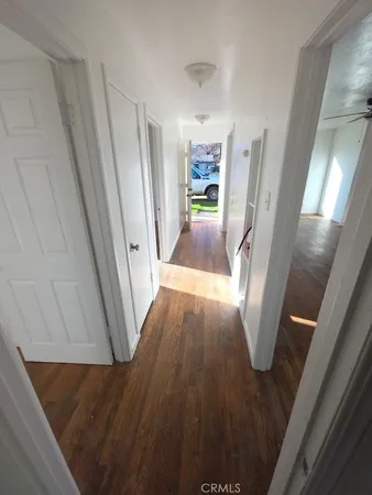 a view of a hallway view with wooden floor and staircase