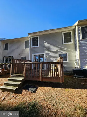 a view of a house with wooden fence