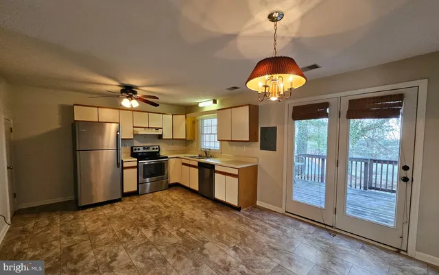 a kitchen with refrigerator and window
