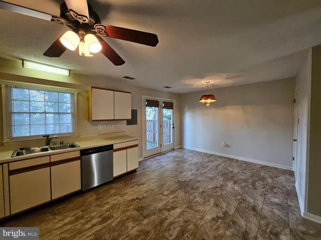 a kitchen with stainless steel appliances granite countertop a sink and cabinets