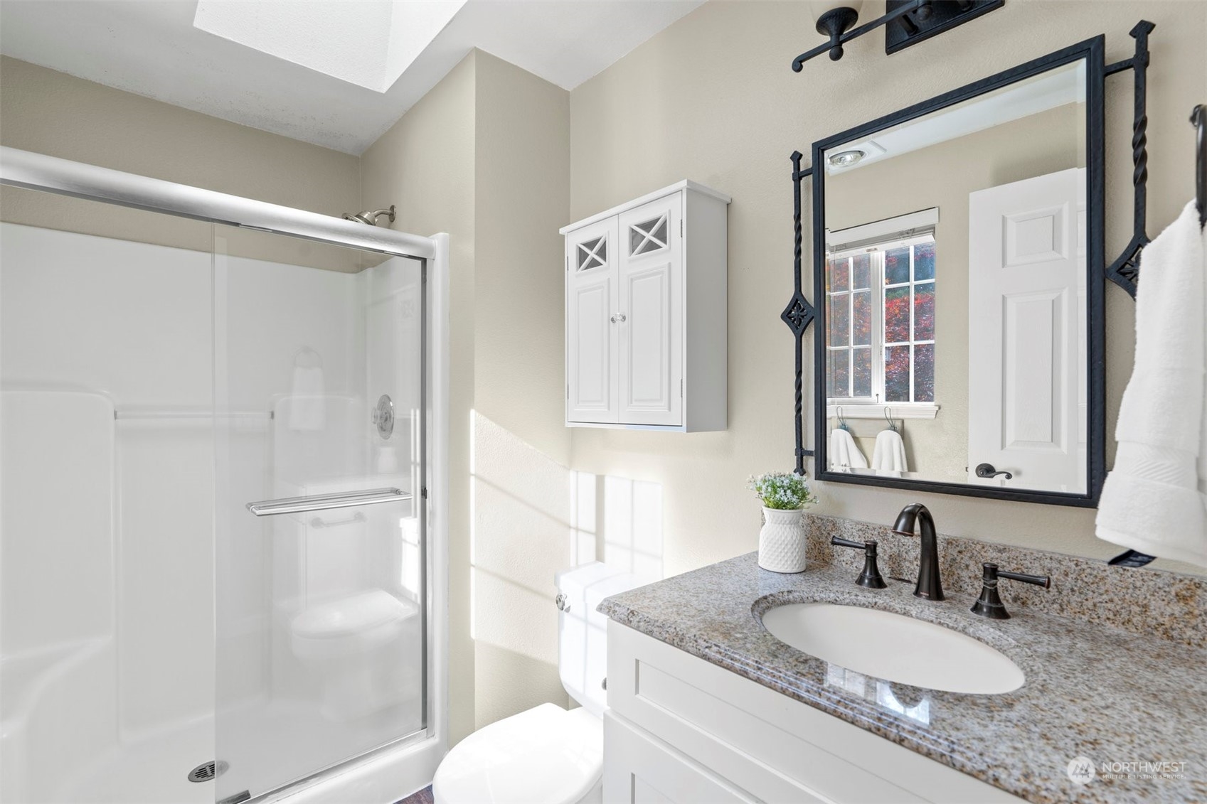 27403 Northeast 30th Way Redmond, WA 98053 - Photo 18 of 34 a bathroom with a granite countertop sink mirror and a shower