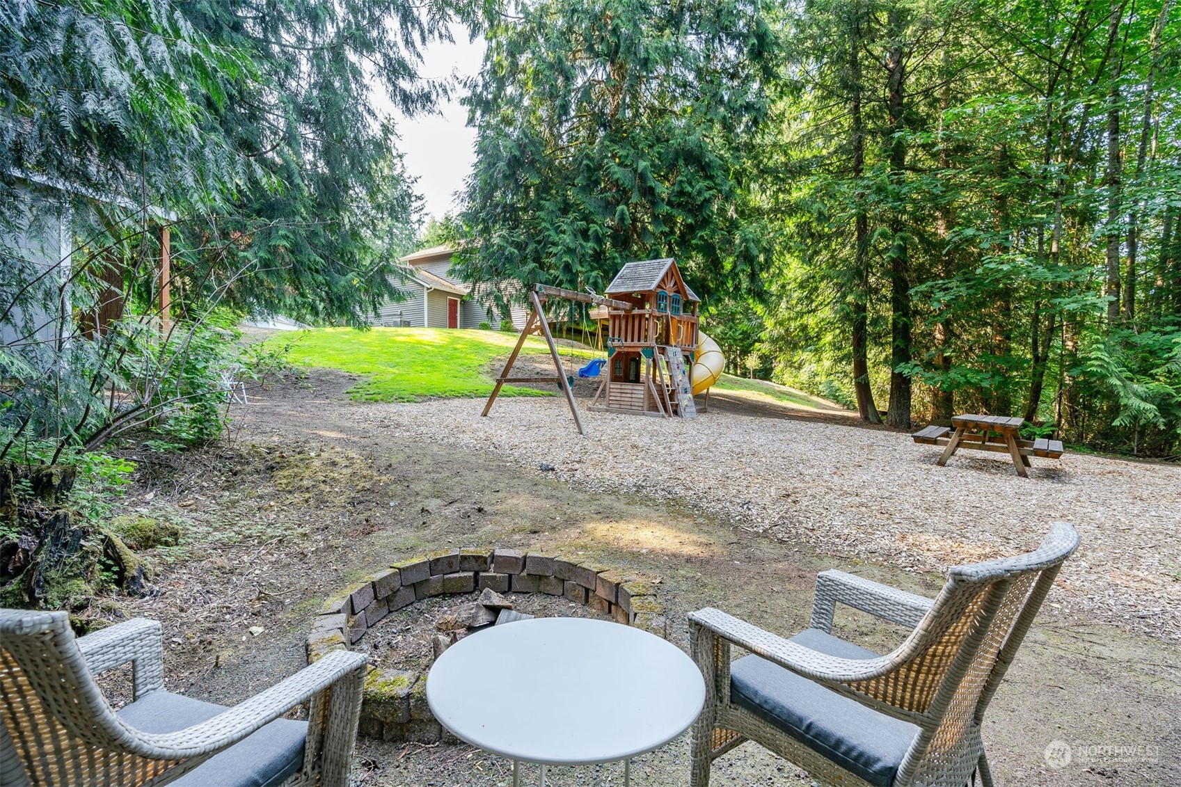 27403 Northeast 30th Way Redmond, WA 98053 - Photo 26 of 34 a backyard of a house with table and chairs