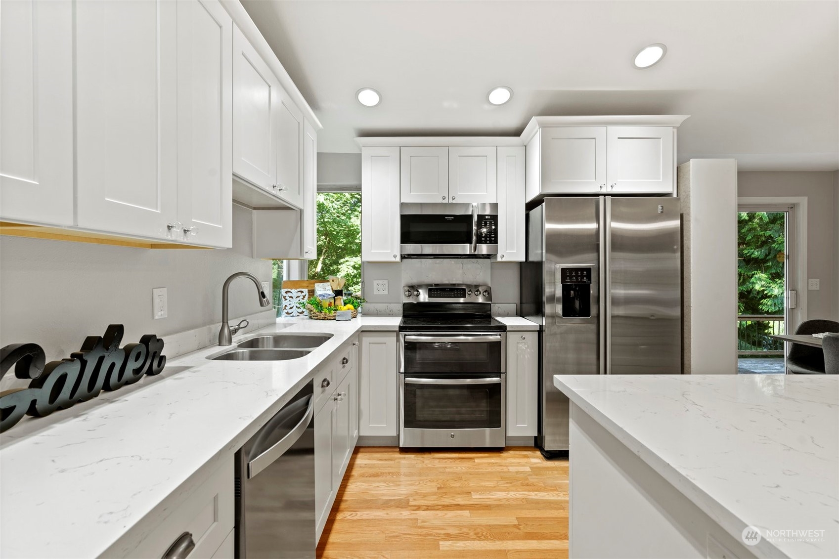 27403 Northeast 30th Way Redmond, WA 98053 - Photo 3 of 34 a kitchen with a sink stainless steel appliances and white cabinets