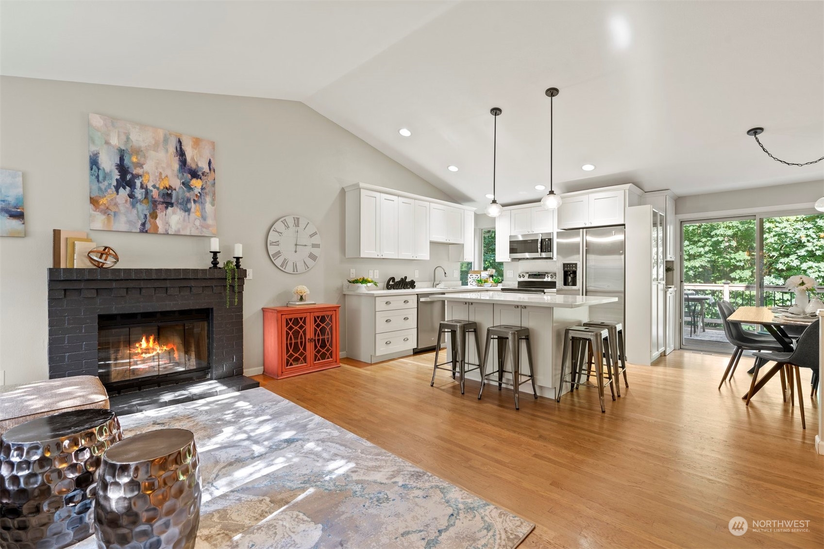 27403 Northeast 30th Way Redmond, WA 98053 - Photo 6 of 34 a open kitchen view with fireplace a dining table and chairs
