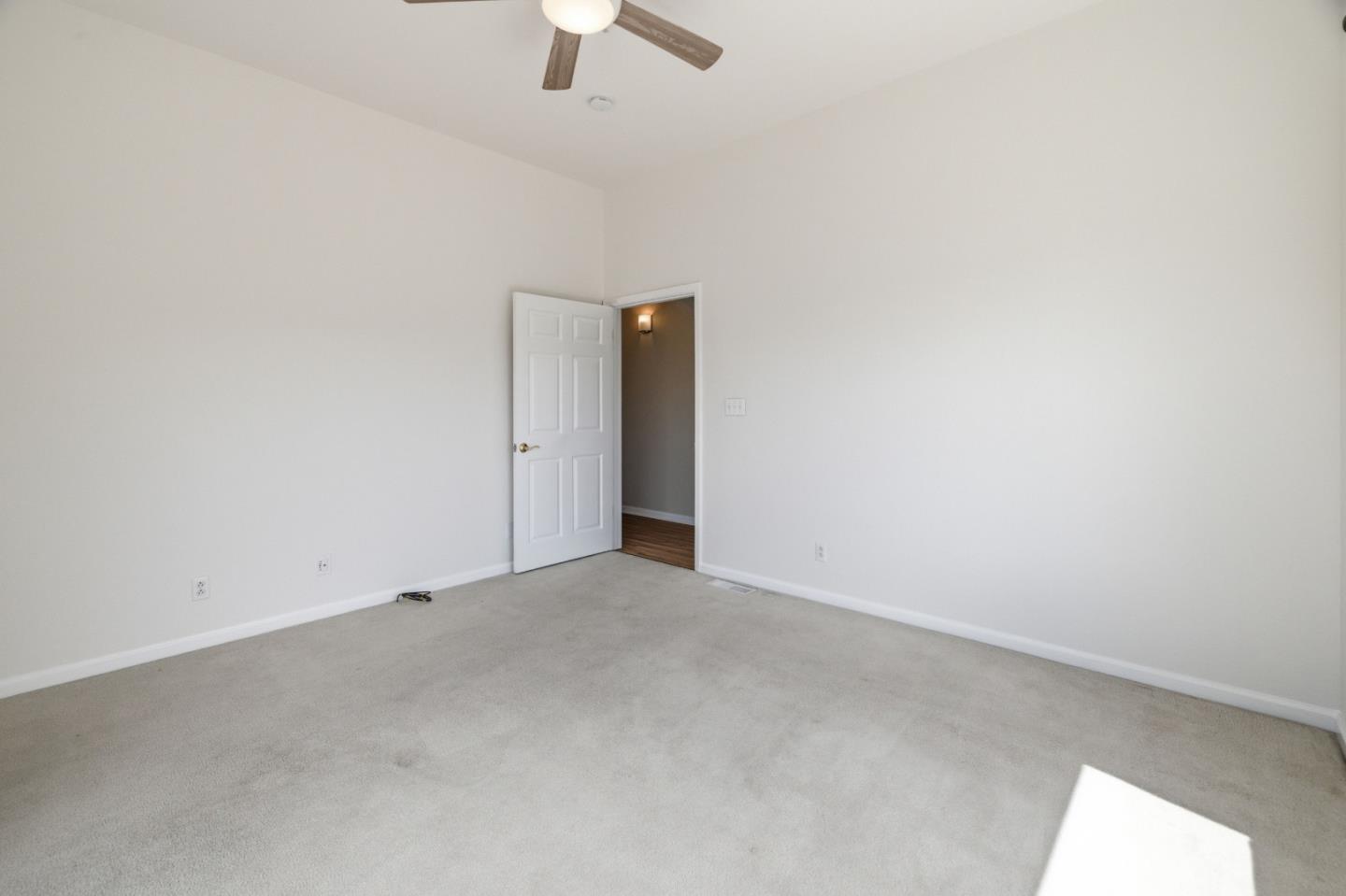 19269 Mallory Canyon Road, Unit D Salinas, CA 93907 - Photo 24 of 77 an empty room with ceiling fan and window