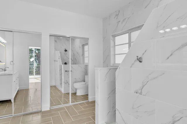 a bathroom with a shower and toilet