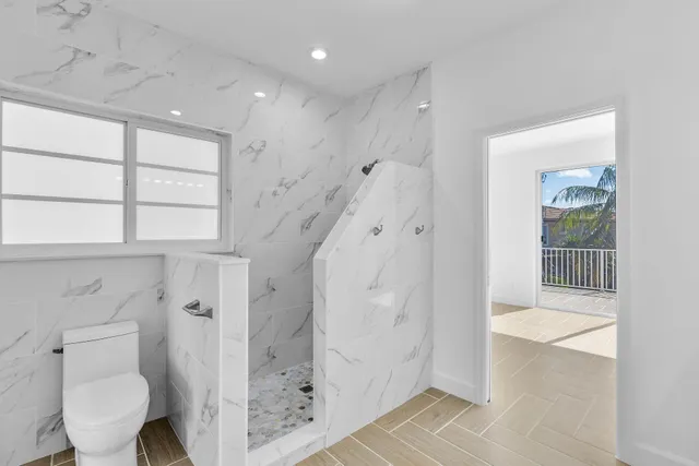 a bathroom with a shower and a toilet