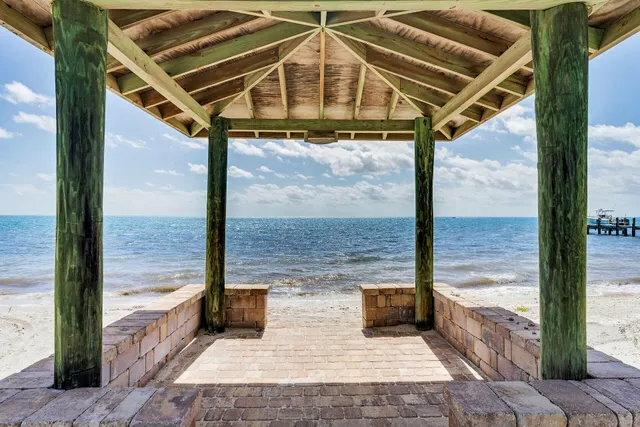 a view of a porch with a floor to ceiling window with wooden floor