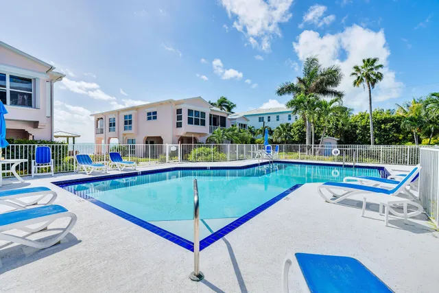a swimming pool with outdoor seating and yard