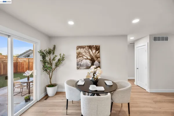 a living room with furniture and potted plant