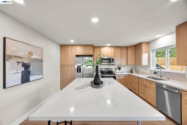 a kitchen with lots of counter top space and wooden floor