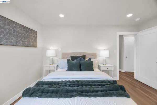 a bedroom with a bed and a night stand