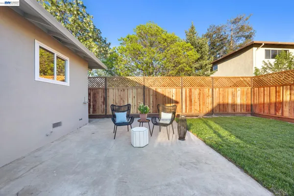 a view of a patio with table and chairs and potted plants