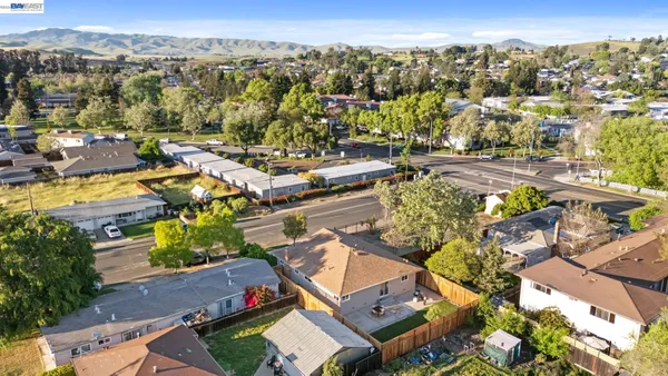 an aerial view of residential houses with outdoor space