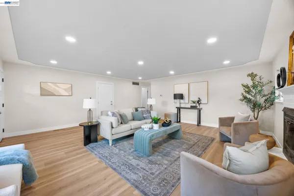a living room with furniture and a potted plant