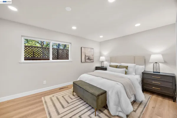 a bedroom with a bed and a painting on the wall